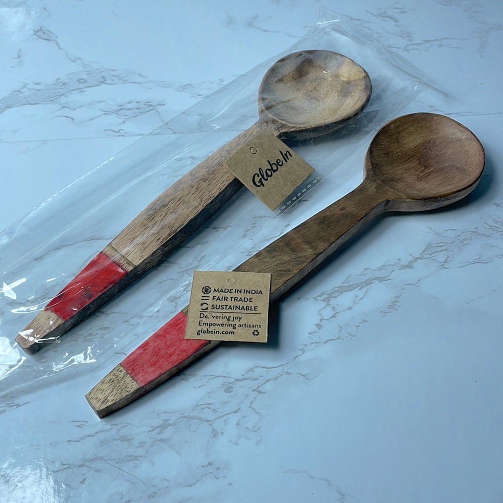 Set of two wooden serving spoons handmade in India. Bone and brass accents.